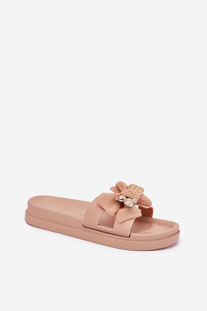 Stylish rubber flip-flops for women by Step in Style, showcasing a sophisticated design with cut-outs and a golden brooch, perfect for warm weather elegance.