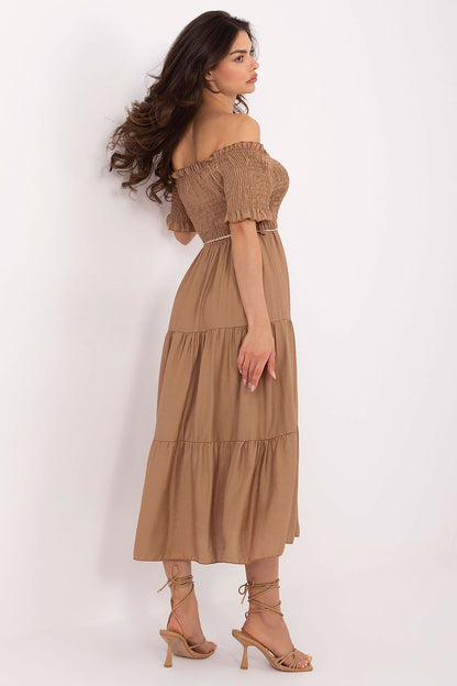 Model wearing Italy Moda's stylish summer midi dress in EU size 0, emphasizing the elegant silhouette with a waist tie detail and flared design.