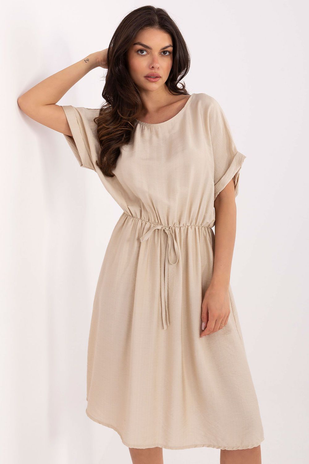 Model wearing Italy Moda stylish flared viscose summer dress with waist tie, showcasing its versatility and comfort in a chic outdoor setting.