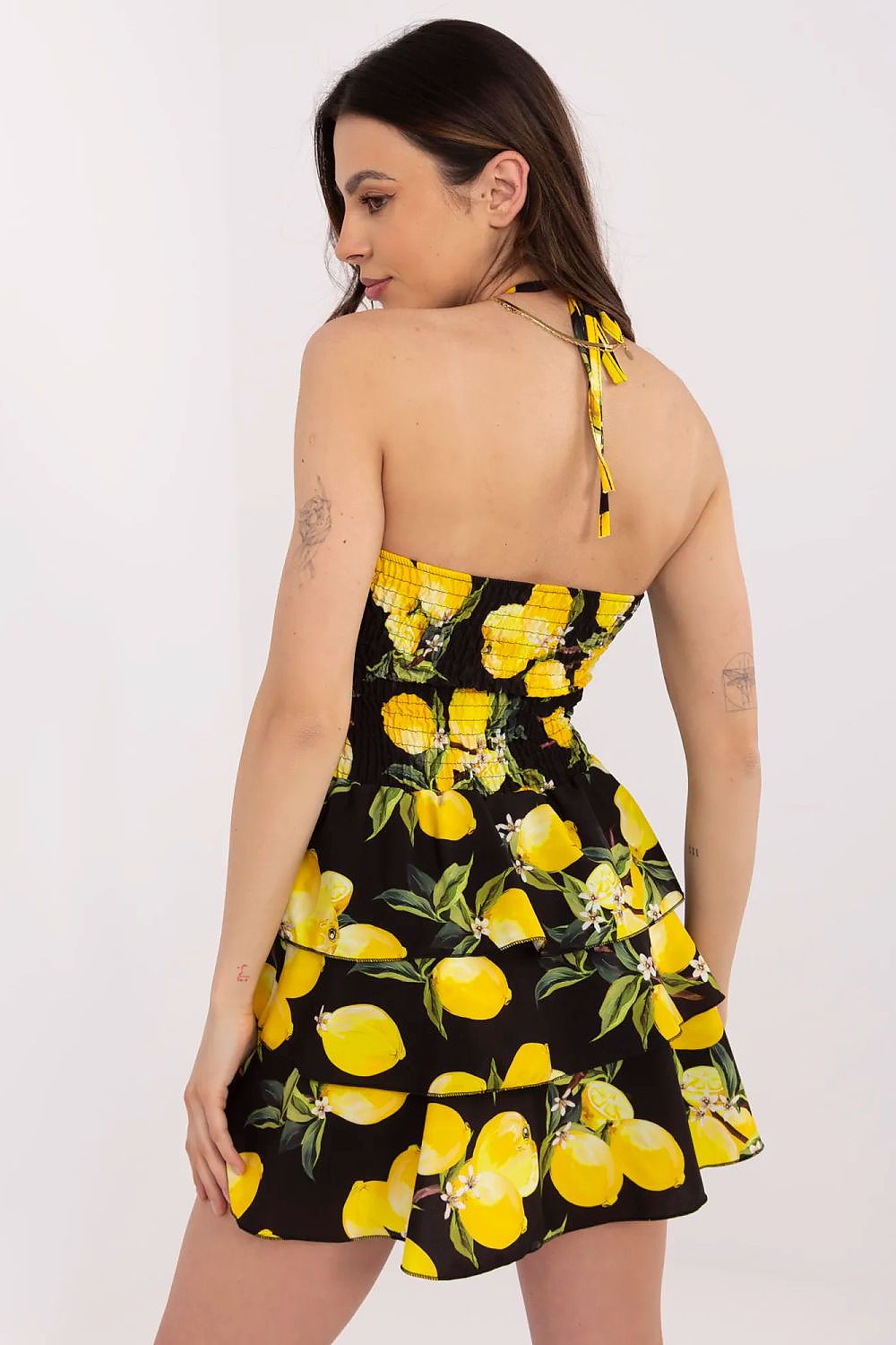 Italy Moda Women's summer mini dress styled for a chic outdoor event, emphasising the playful frill at the hem and lively print.