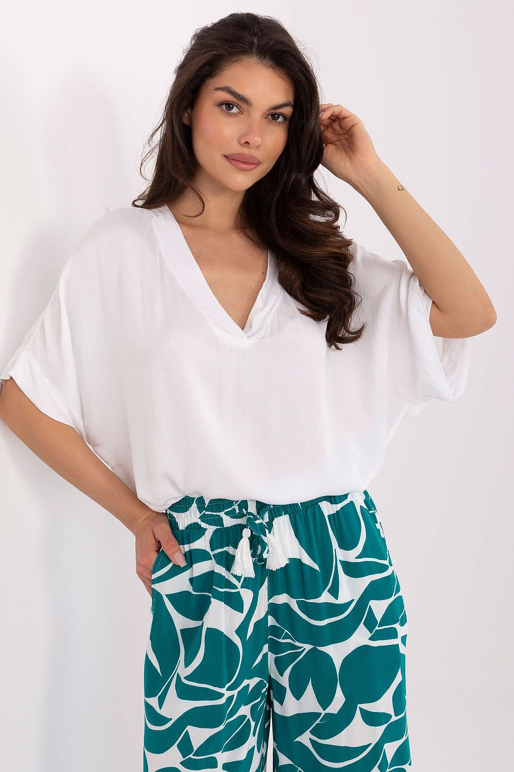 Model wearing the Och Bella elegant viscose blouse, styled with jeans for a sophisticated yet casual look.