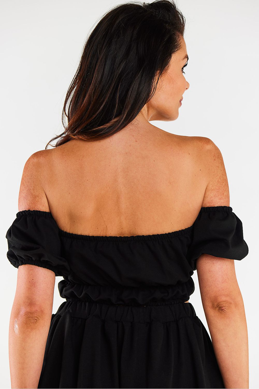 Versatile Infinite You blouse featuring an elasticised waist and sleeves, designed for a comfortable and flattering fit during warm weather.