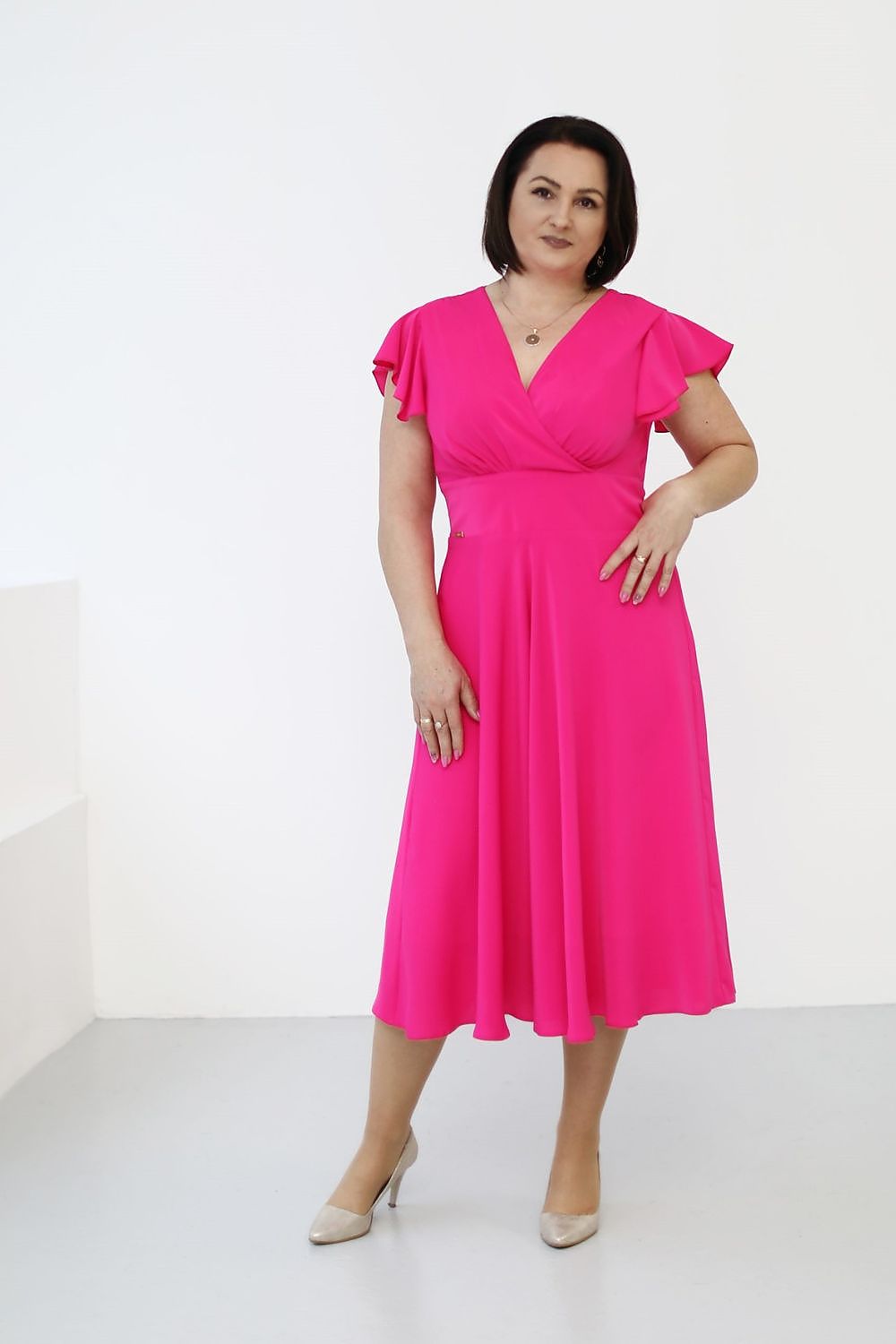 Elegant midi cocktail dress by Jersa featuring a wrap top, flowy sleeves, and a feminine silhouette, perfect for special occasions. Available in sizes XS to XXXL.