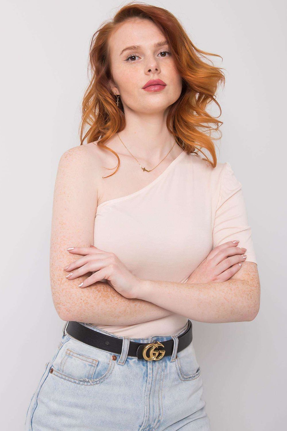 Model wearing Rue Paris asymmetrical one-sleeve blouse, highlighting its unique neckline and comfortable fit, ideal for fashionable women.