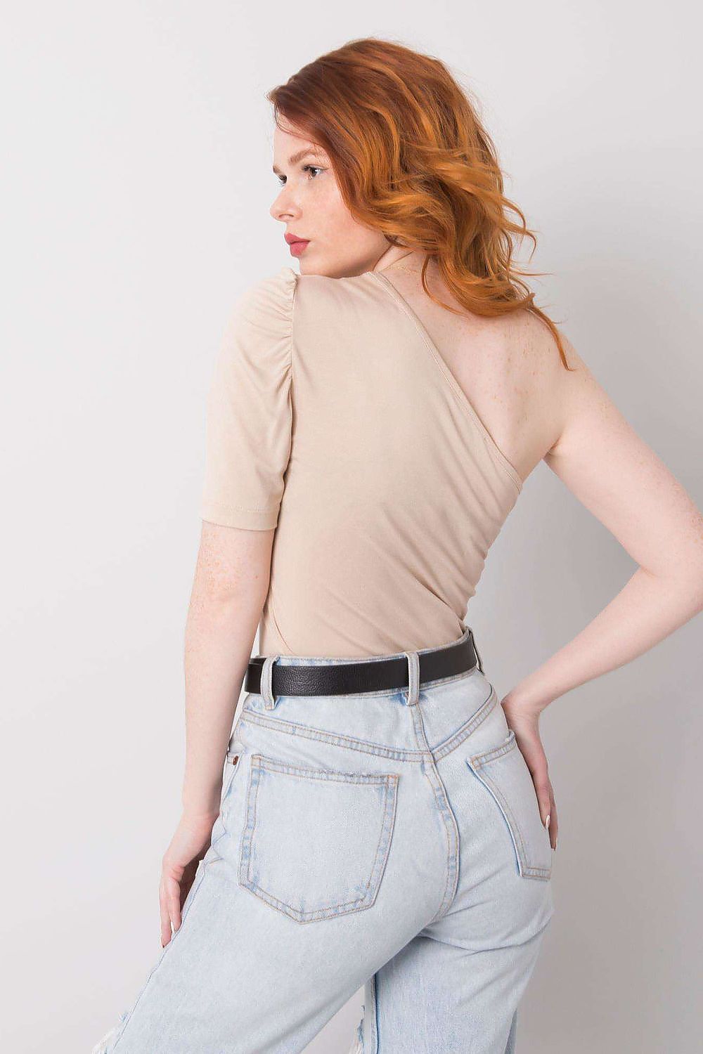 Chic Rue Paris asymmetrical one-sleeve blouse paired with high-waisted jeans, perfect for a contemporary casual look.