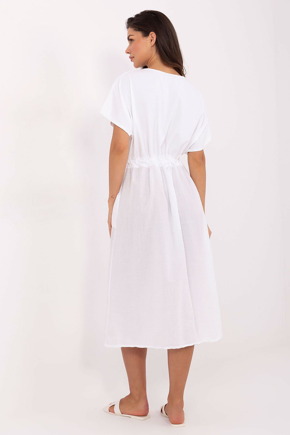 Stylish presentation of Och Bella's midi summer dress in a vibrant setting, capturing its timeless design with short sleeves and round neckline.