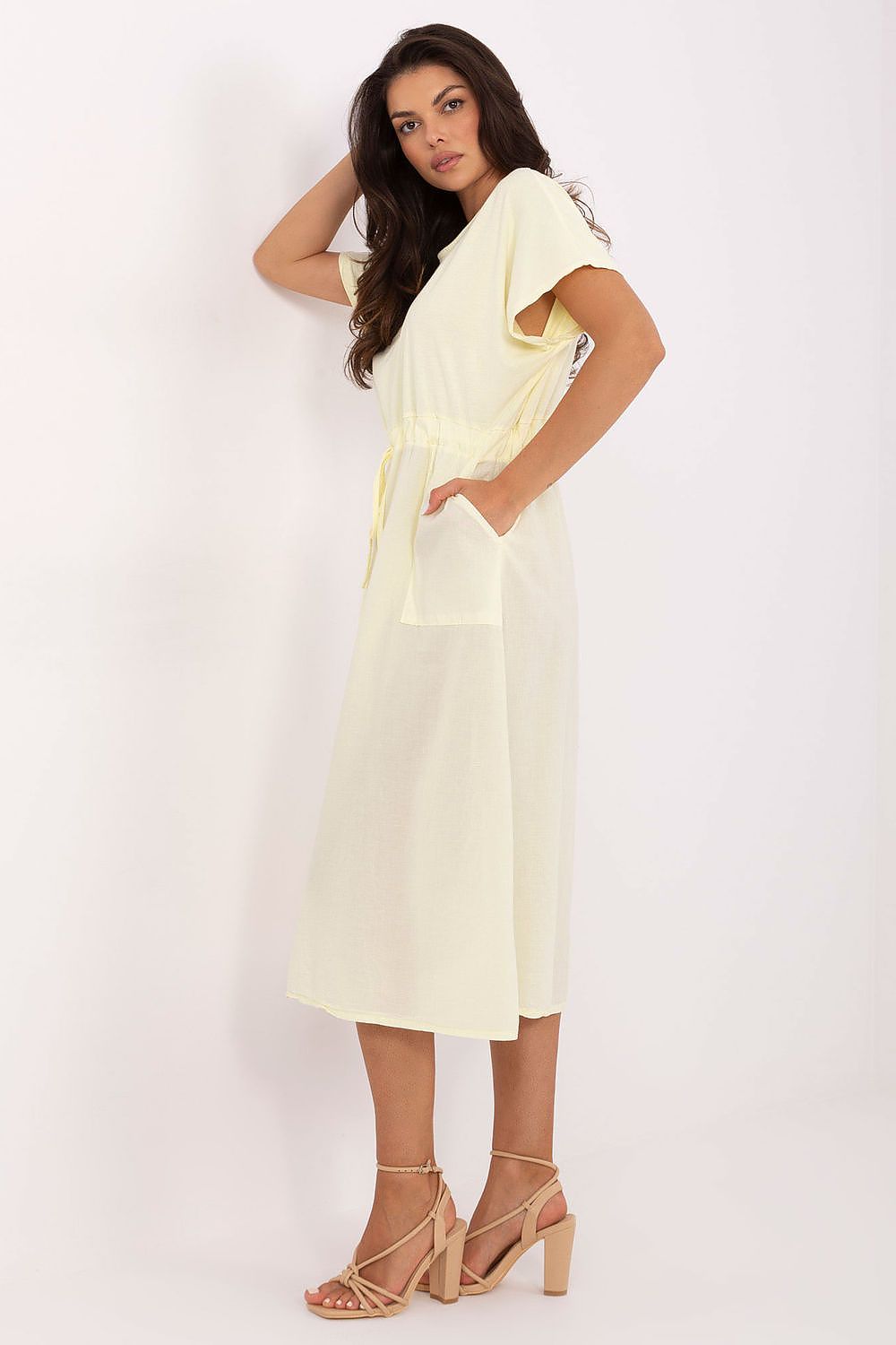 Elegant model wearing Och Bella's cotton midi summer dress, demonstrating its flattering flared cut and chic tie waist for a sophisticated summer look.