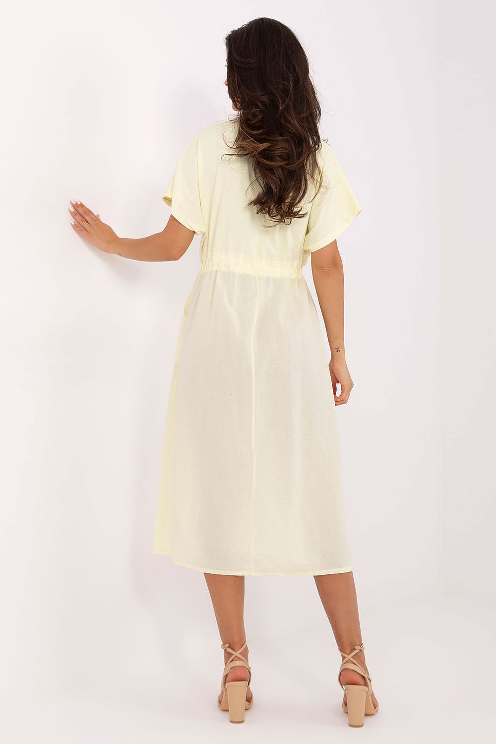 Och Bella's beautiful midi summer dress displayed on a hanger, featuring a classic round neckline and practical pockets, perfect for the discerning fashionista.
