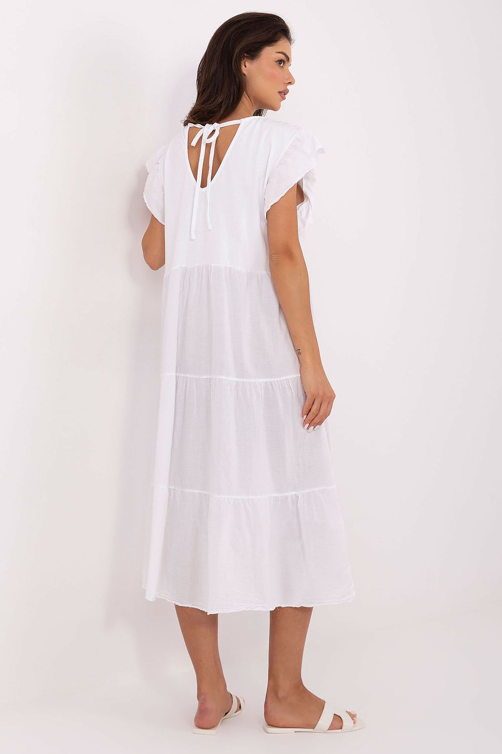 Close-up of Och Bella’s luxurious cotton dress detailing, highlighting the soft fabric, feminine frill sleeves, and exquisite tie back.