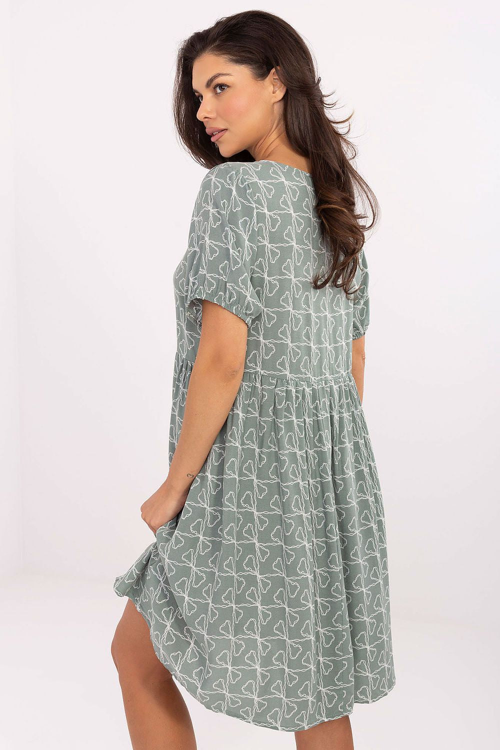 Back view of Summer Flare Dress by Sublevel, highlighting the graceful drape and flared bottom that ensure comfort and elegance.