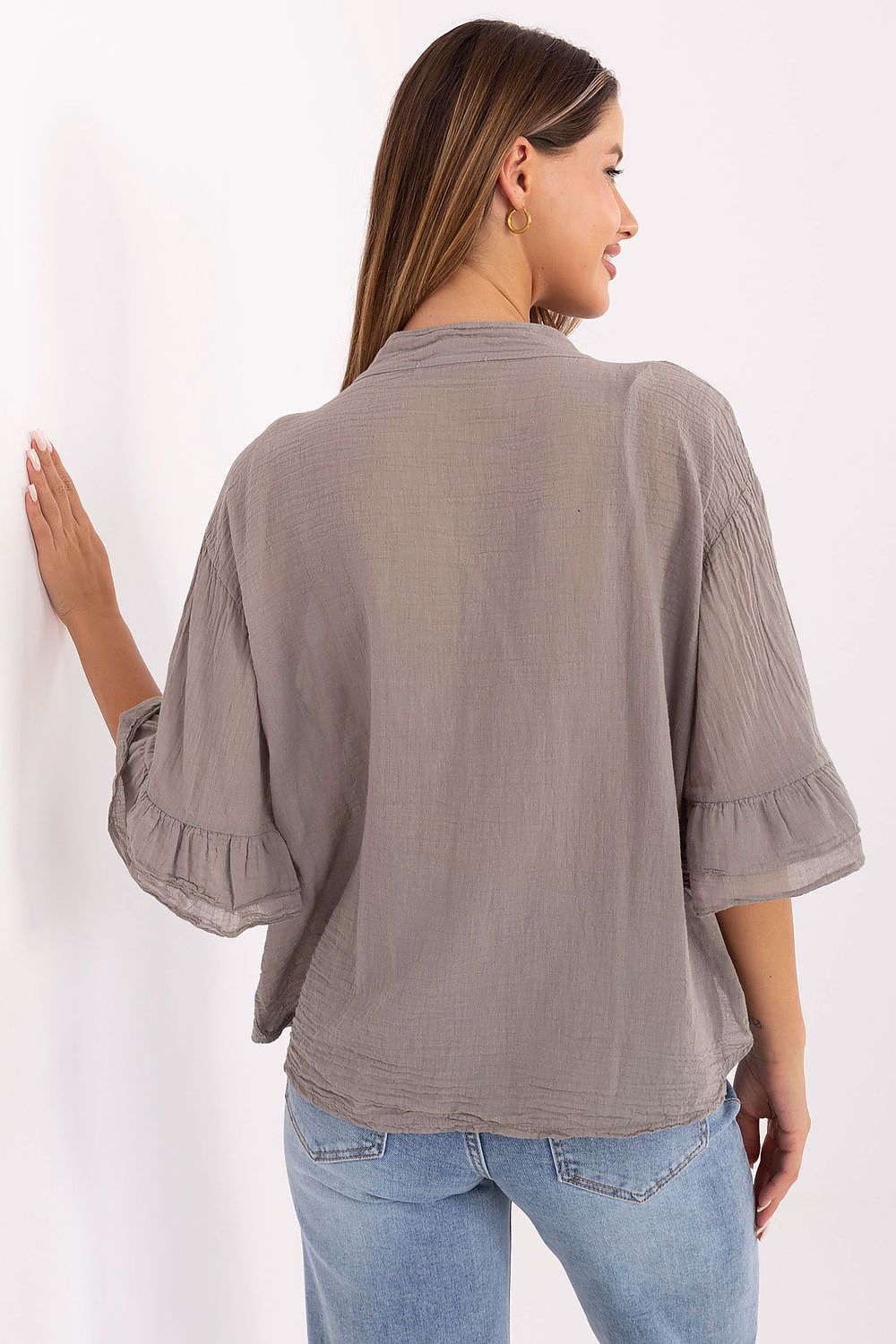 Stylish display of Italy Moda's Luxury Women's Boho Shirt, highlighting the unique ruffle at the front and classic button closure for a chic look.