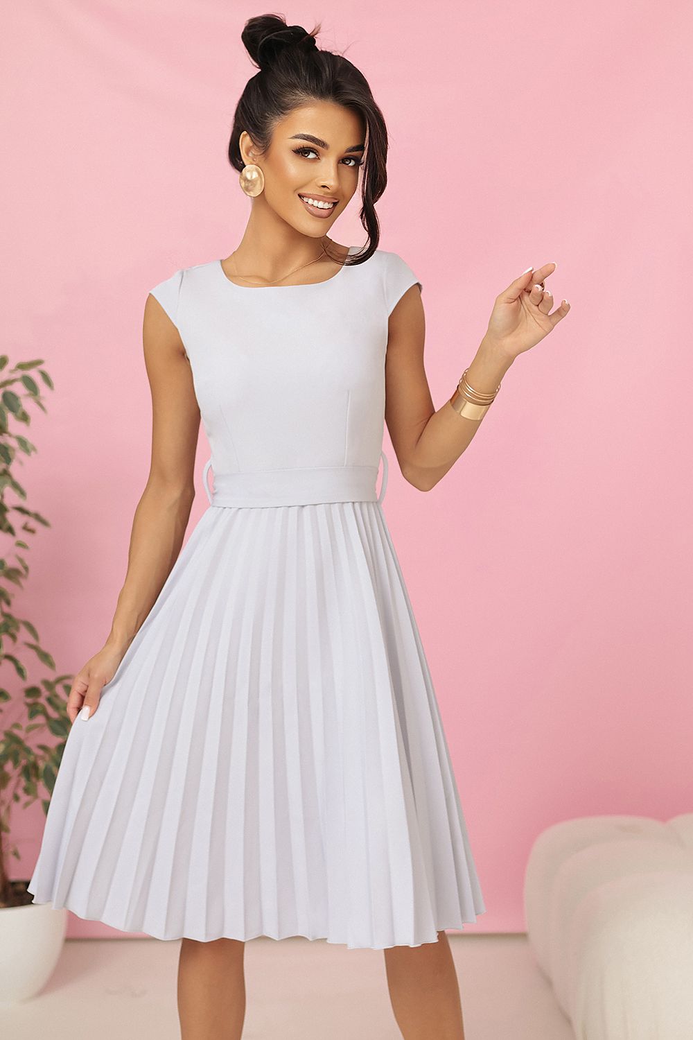 Elegant pleated midi dress by Numoco, showcasing a delicate neckline and flared pleated bottom, perfect for special occasions.