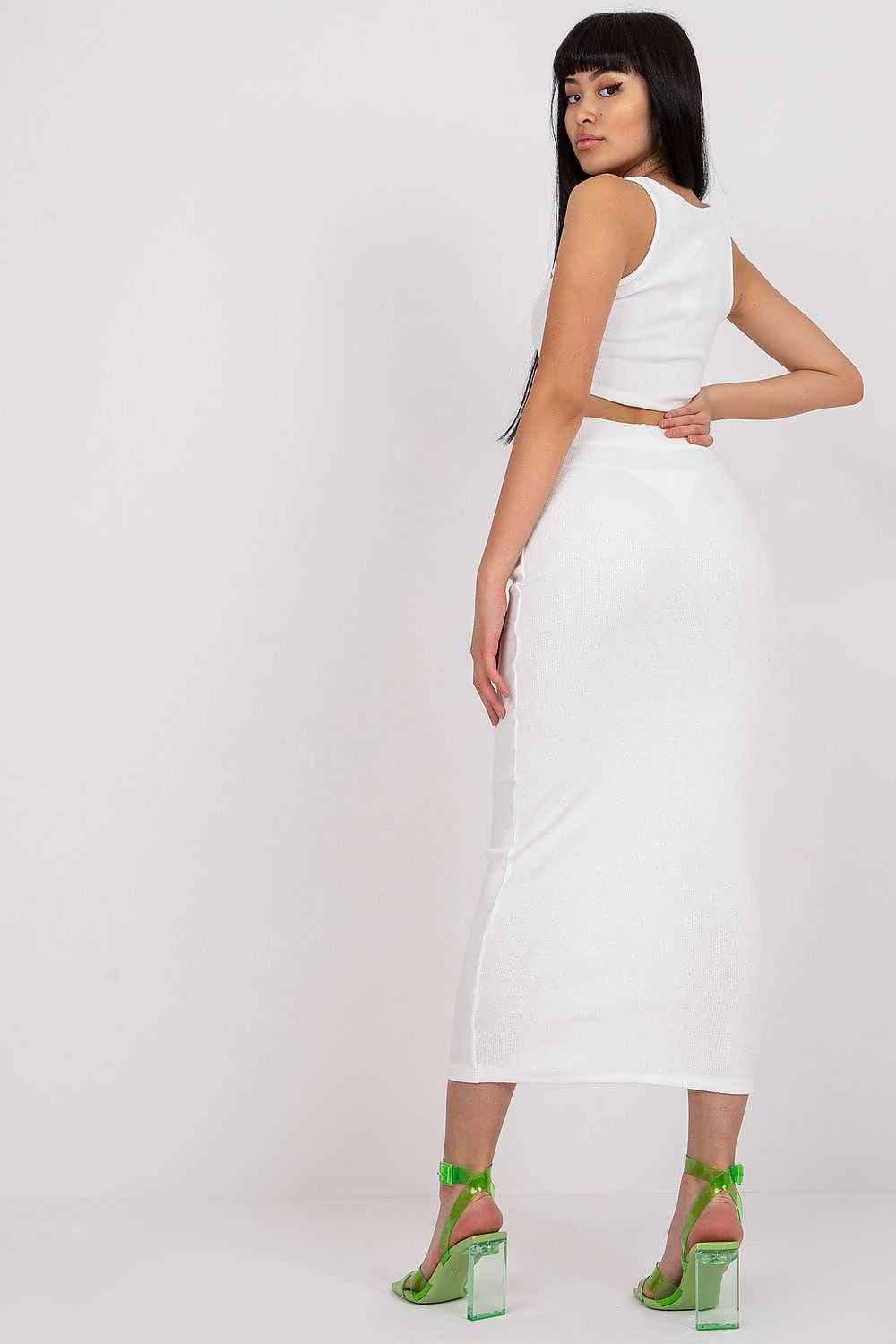 Fashion model wearing Rue Paris ribbed women's ensemble, styled with sporty footwear and elegant accessories for versatile occasions.