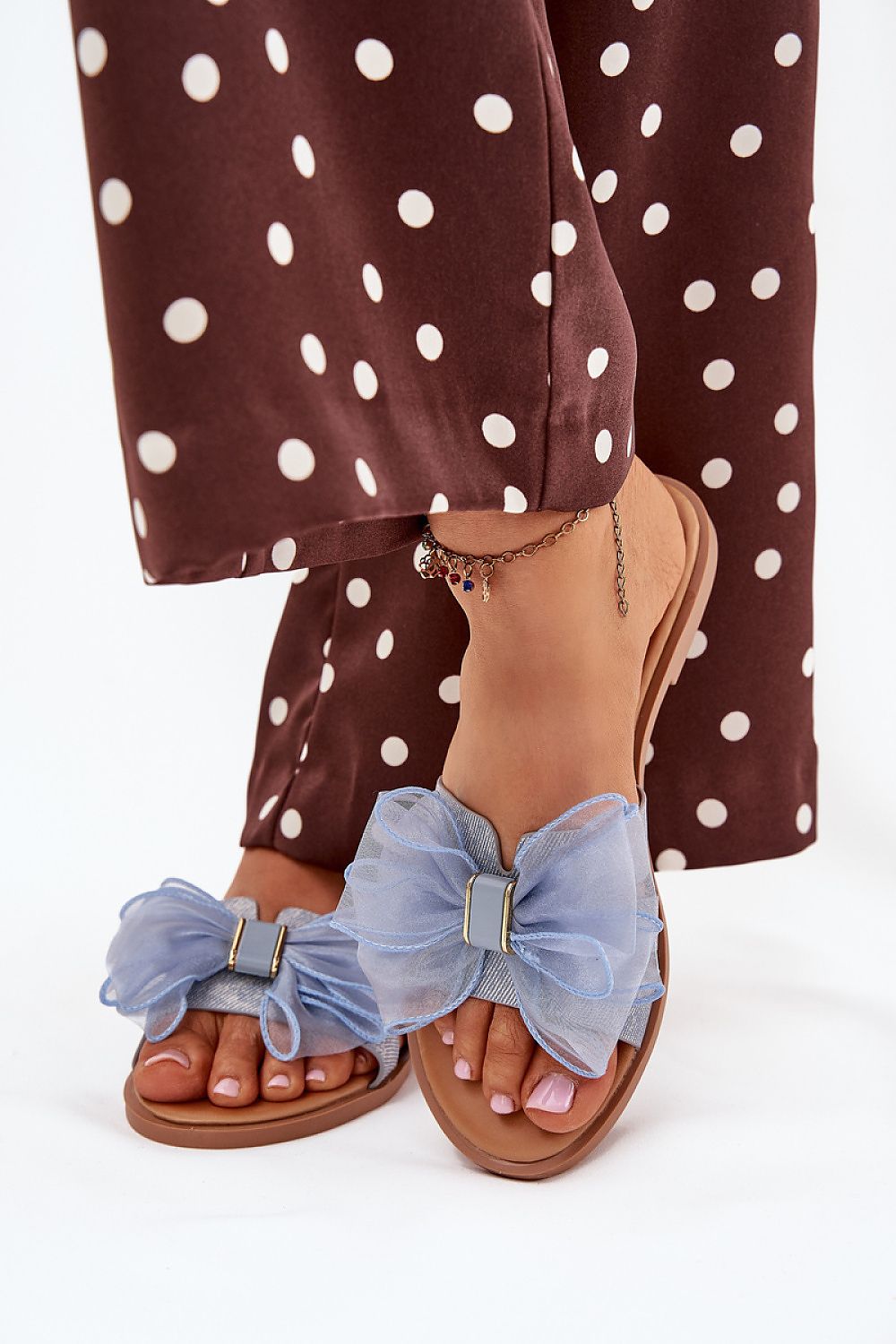 Luxury women's flip-flops by Step in Style featuring elegant tulle bow detail on a flat heel, perfect for summer wear.