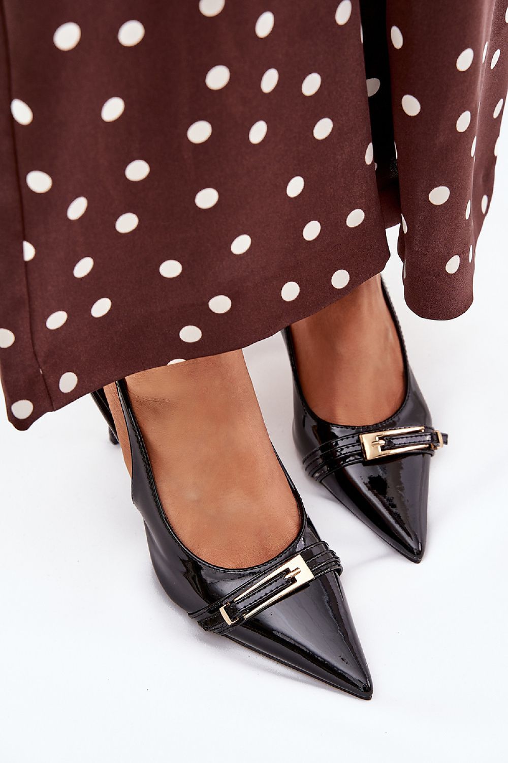 Sophisticated pumps with pointed toes and a striking gold buckle from Step in Style, embodying luxury and elegance.