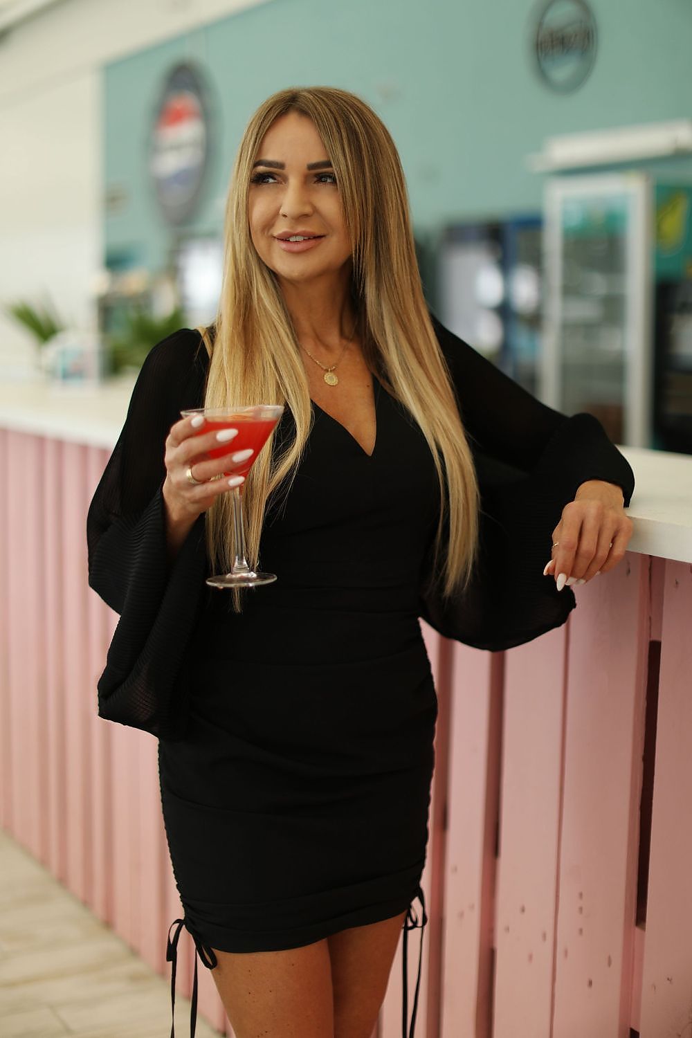 Elegant feminine flowing dress by Jersa, featuring a deep V-neck and adjustable length, perfect for summer occasions.