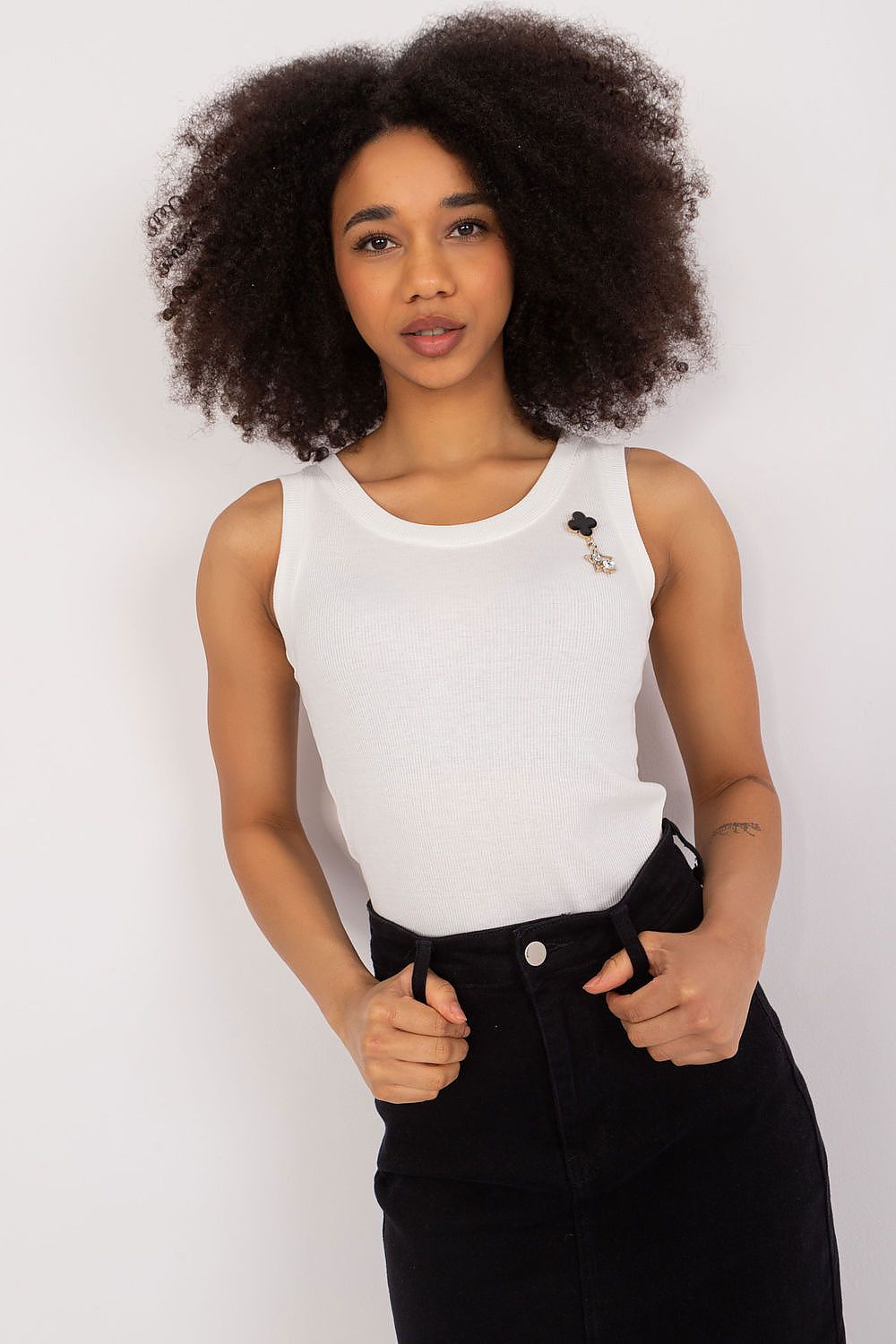 Elegant sleeveless ribbed top by Lakerta featuring a stylish brooch, perfect for a luxury casual look.