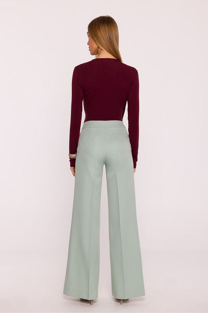 Close-up view of elegant women's trousers by Moe, highlighting the luxurious matte finish and refined creased cuffs.