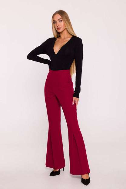 Back view of Moe's elegant high-waisted flared trousers for women, showing concealed zipper closure and chic side pockets.