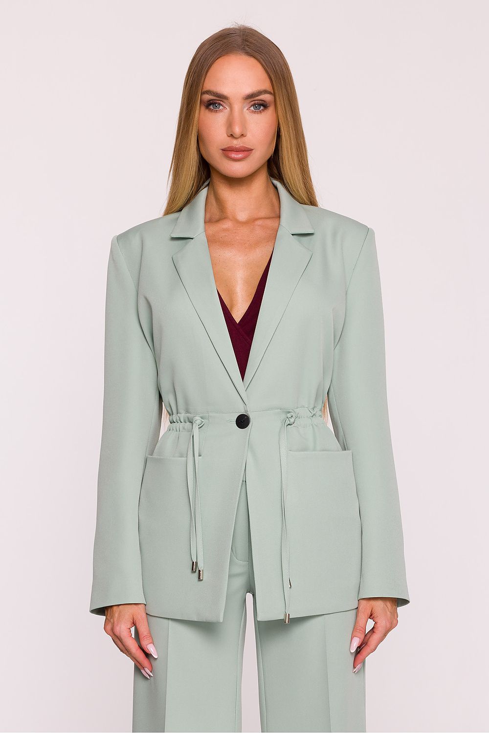 Elegant oversized women's blazer in a classic style by Moe, featuring adjustable waist cords, long sleeves, and patch pockets, perfect for both formal and casual outfits.