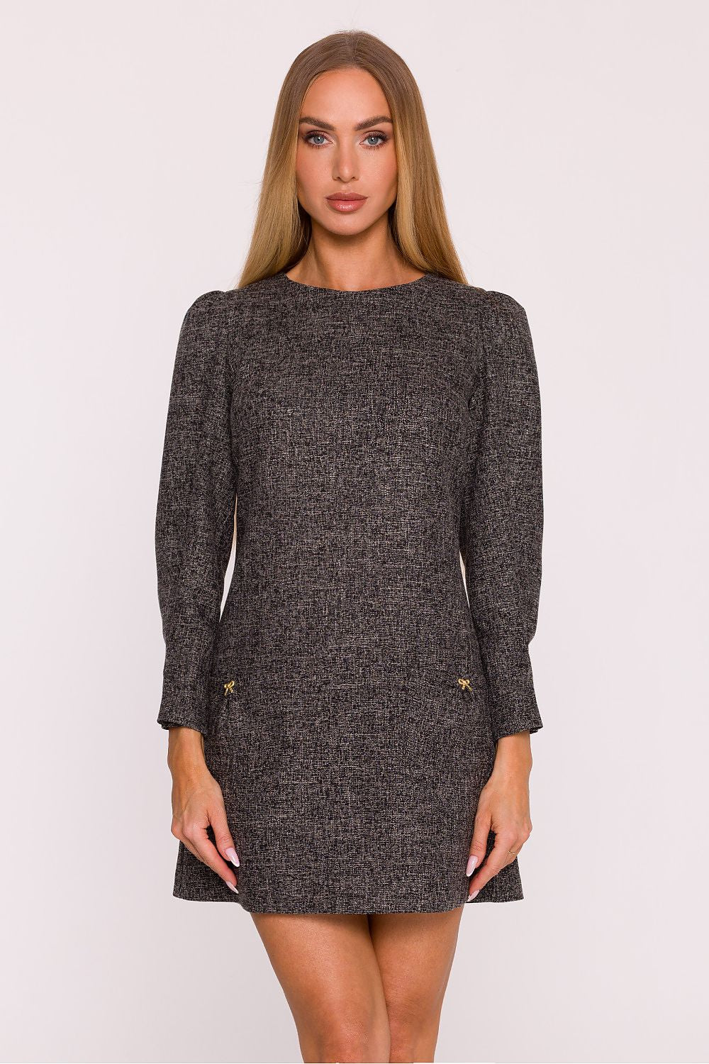 Model wearing the mini length tweed daydress by Moe, exuding a light and modern charm with a flattering trapezoidal cut.
