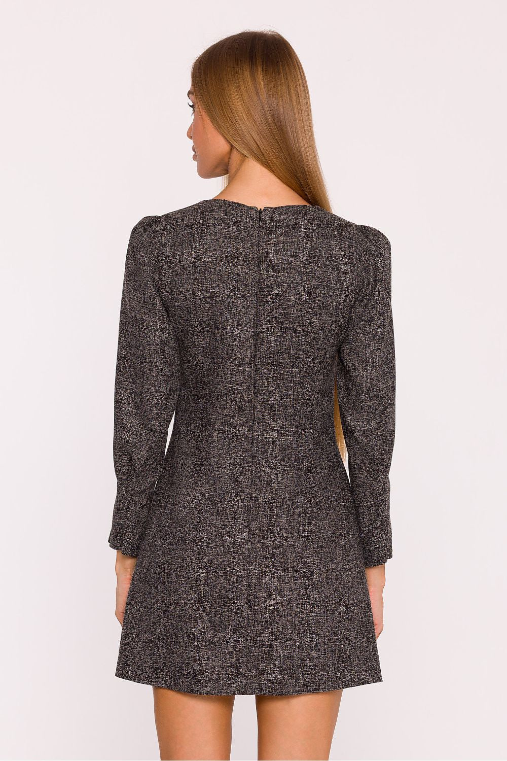 Close-up of the exquisite tweed texture and structured silhouette of Moe's boat neck daydress, featuring delicate shoulder gathers and decorative pockets for a luxurious touch.