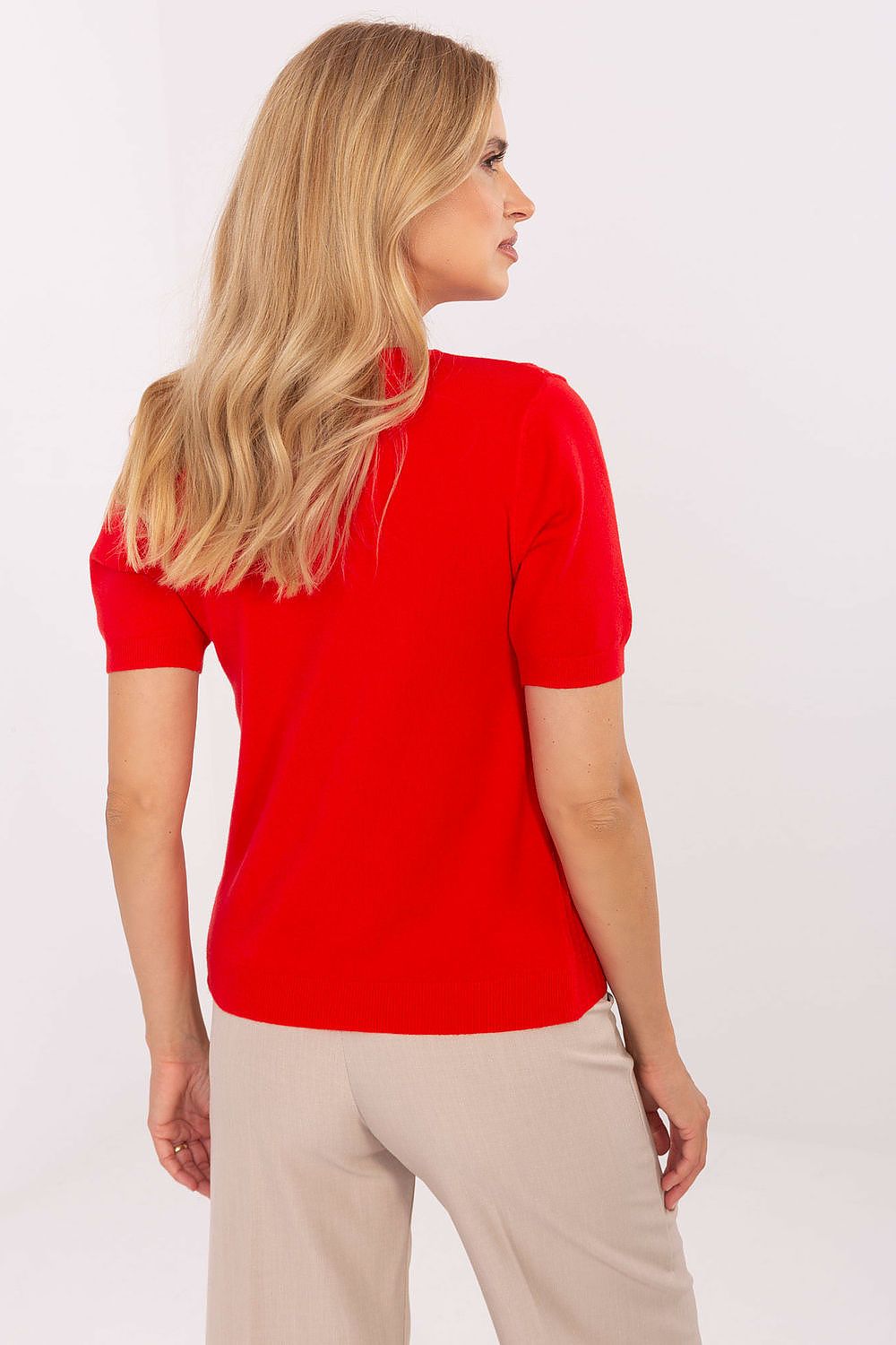 Model showcasing the Elegant V-Neck Short Sleeve Women's Sweater by Factory Price in a fashionable setting, highlighting its versatility and luxurious feel.