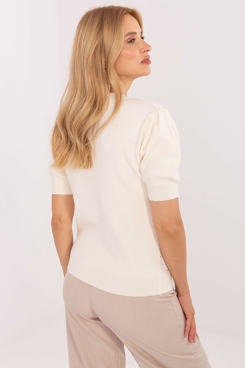 Display of the elegant design of a women's sweater by Factory Price, suitable for pairing with skirts and trousers for chic everyday looks.