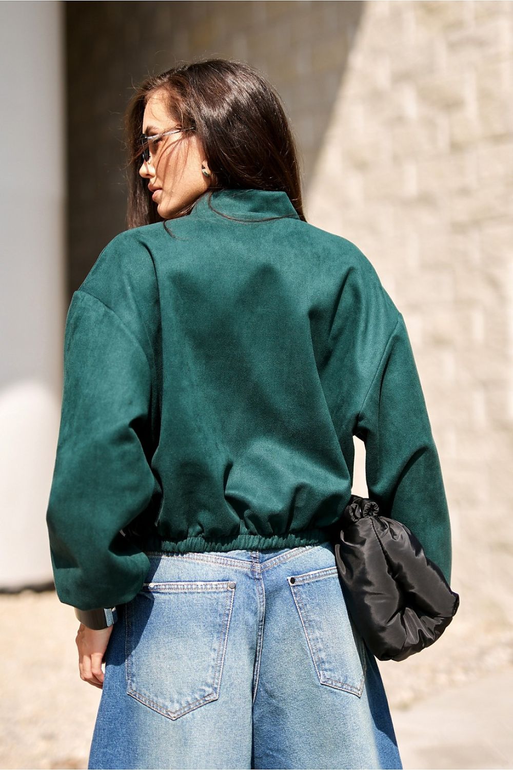 Styled outfit featuring Roco Fashion oversized bomber jacket paired with jeans and sneakers, displaying a chic urban contrast.