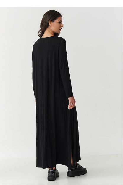 Stunning Makadamia Maxi Dress in black, showcasing its flattering silhouette with side slits and long sleeves, ideal for year-round wear.