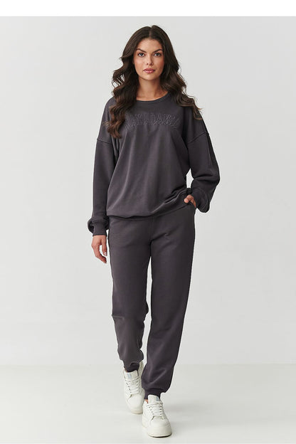 Model wearing Makadamia's luxurious embroidered cotton tracksuit set, perfect for casual outings.