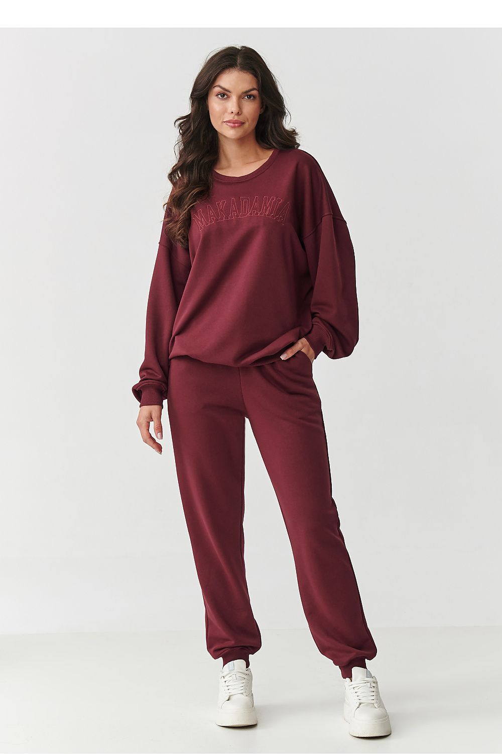 Makadamia luxury women's tracksuit set displayed on a model, illustrating the perfect fit and sophisticated style for everyday elegance.