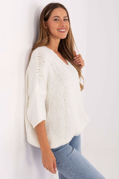 Model wearing Italy Moda's women's oversized V-neck sweater, showcasing a graceful silhouette and 3/4 sleeves for a chic, relaxed look.
