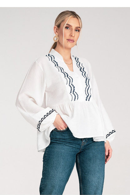 Model wearing the Figl Blouse, exuding elegance and class in a fashionable setting, available in EU S/M and US S/M sizes.