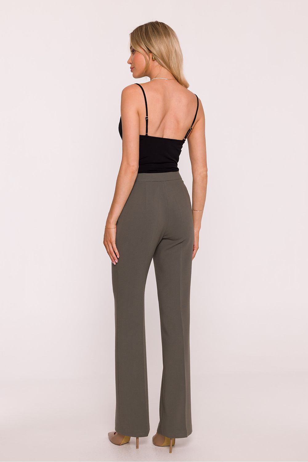 Stylove classic women's trousers styled in a formal outfit, featuring a chic medium rise and pressed crease for an elegant business look.