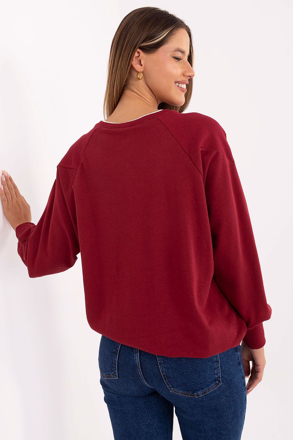 Stylish Relevance women's sweatshirt showcasing a fashionable inscription print and an adjustable tying bottom, perfect for elegant everyday wear.