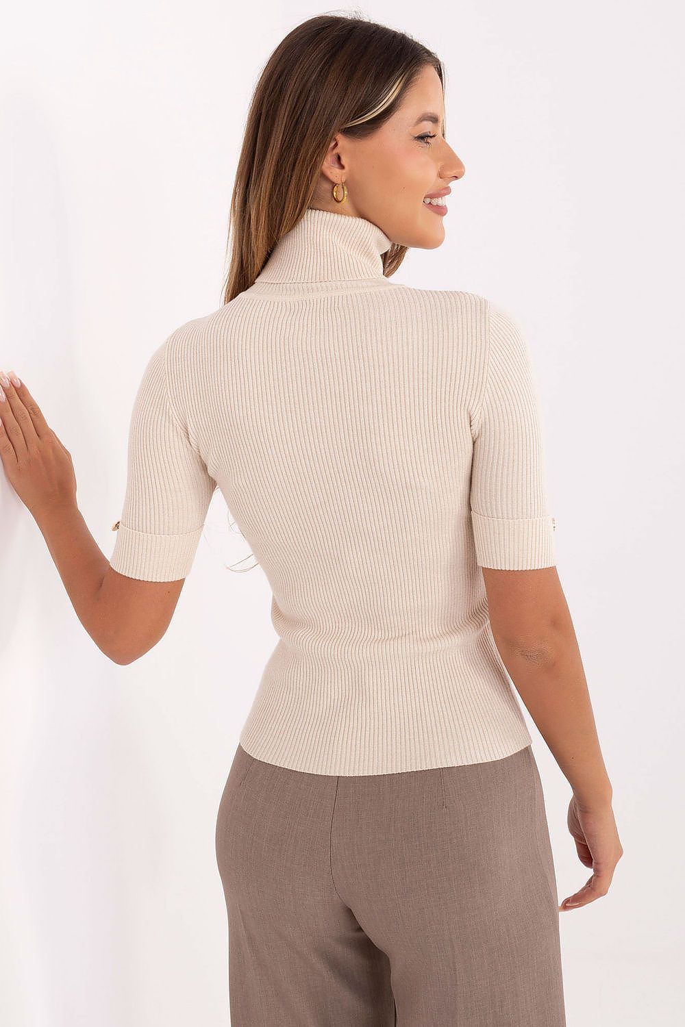 Model wearing an elegant women's short sleeve sweater with turtleneck and ribbed texture by Factory Price, paired with sophisticated attire.