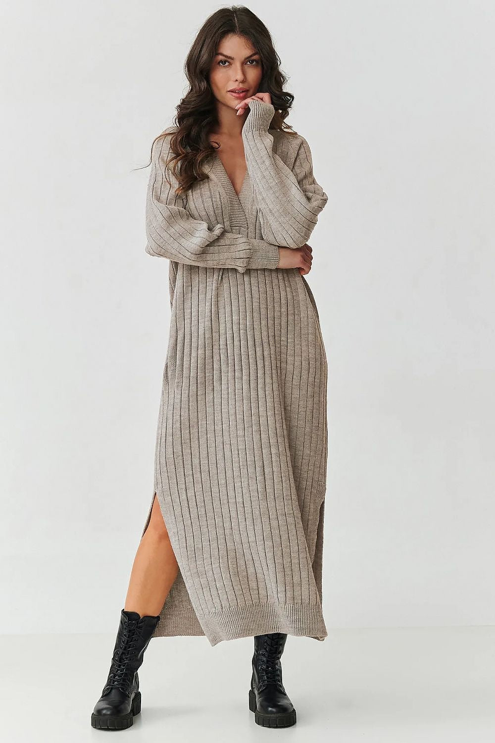 Luxurious Makadamia long sweater dress with V-neck and ribbed knit detailing, perfect for elegant styling and comfort in cooler weather.