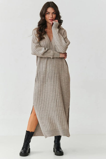 Luxurious Makadamia long sweater dress with V-neck and ribbed knit detailing, perfect for elegant styling and comfort in cooler weather.