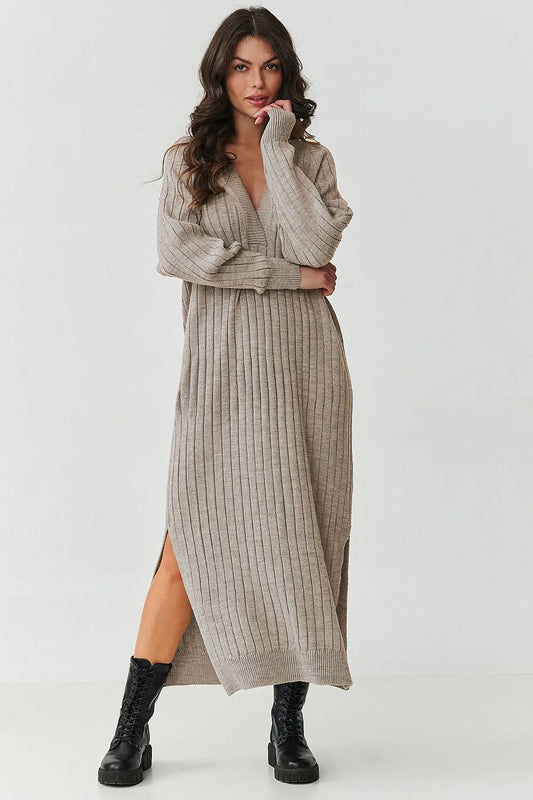 Luxurious Makadamia long sweater dress with V-neck and ribbed knit detailing, perfect for elegant styling and comfort in cooler weather.