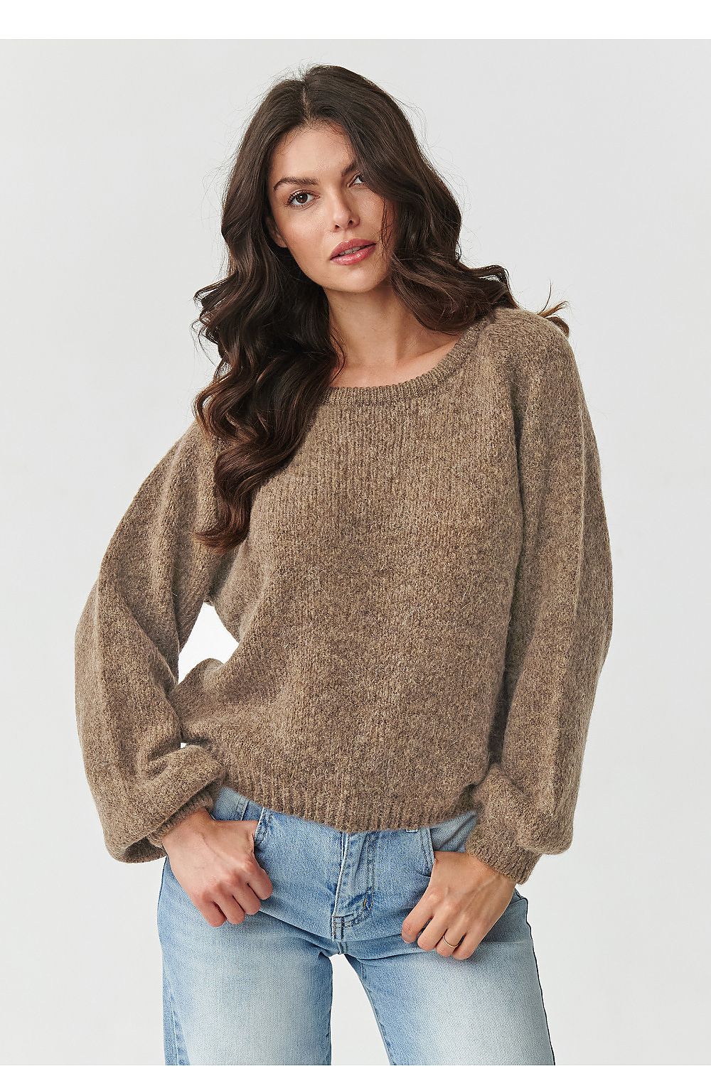 Elegant Makadamia women's jumper draped on a mannequin, highlighting versatile styling options and warm colour palette.