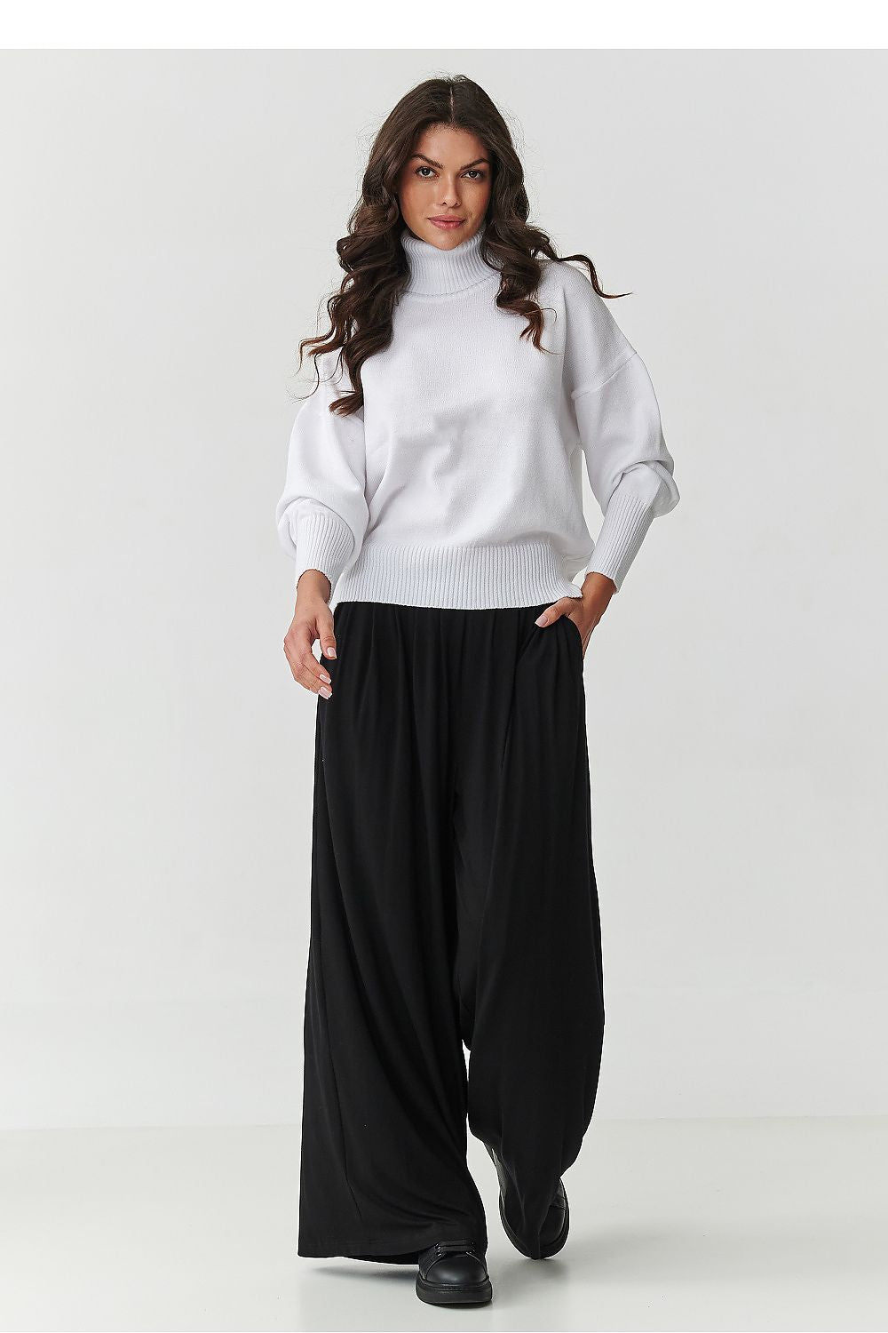 Close-up of the luxurious fabric of Makadamia's Women's Oversized Turtleneck Sweater, highlighting its softness and high-quality materials.