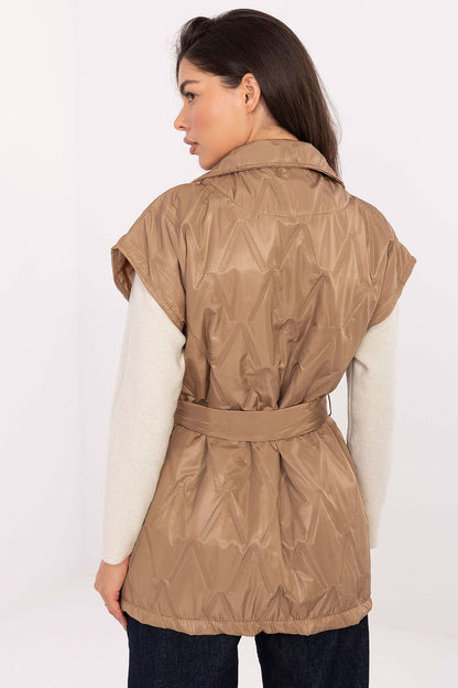 Stunning woman in Rue Paris quilted vest with pockets, showcasing timeless elegance for transitional seasons.