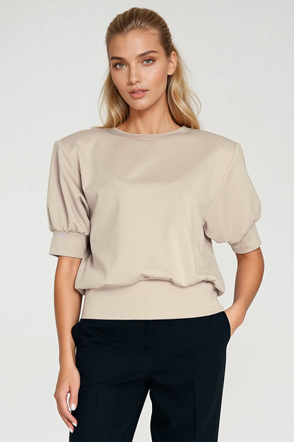 Nife oversized blouse displayed on a mannequin, illustrating the relaxed silhouette and luxurious feel of the fabric.