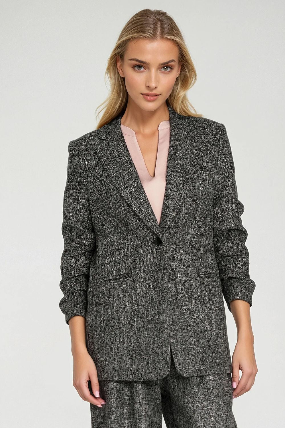 Stylish melange texture women's jacket with shoulder pads by Nife, designed for a sophisticated silhouette.