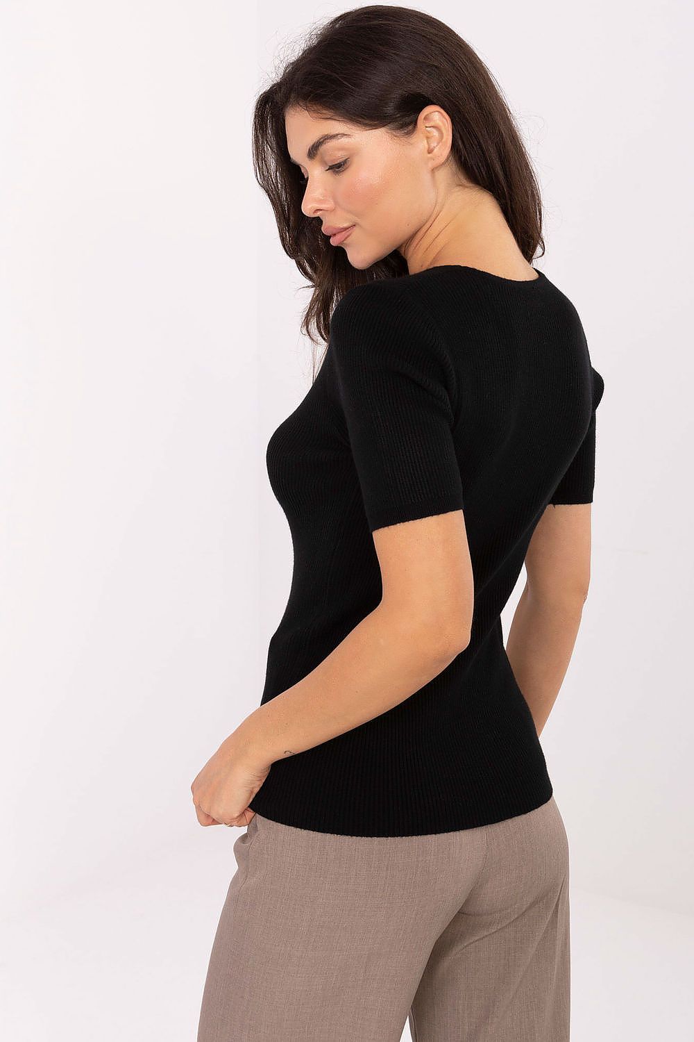 Chic model showcasing luxury short sleeve women's sweater by Factory Price, designed in versatile style suitable for casual and professional settings.