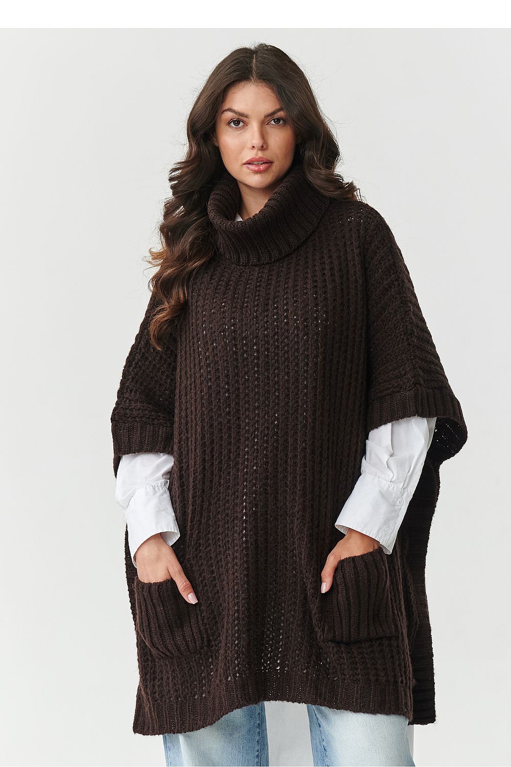 Luxurious poncho-style turtleneck sweater by Makadamia in beige mélange, designed with oversized silhouette and front pockets, perfect for autumn winter wear.