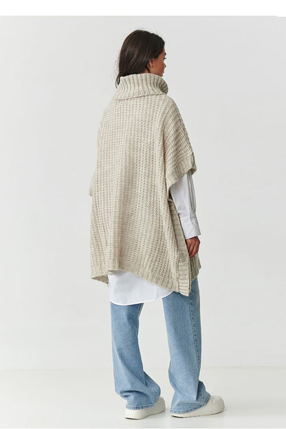 Chic poncho-style turtleneck sweater by Makadamia, featuring a relaxed oversized fit and narrow ribbing, displayed in a sophisticated chocolate hue, ideal for a luxurious winter look.