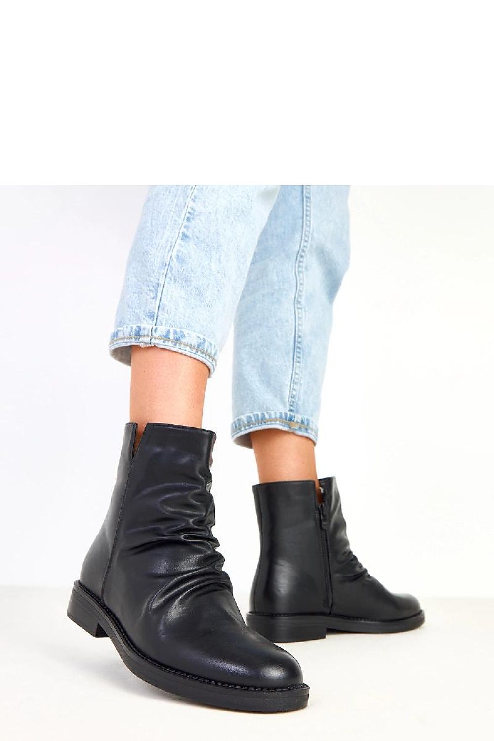 Solea Women's Classic Ankle Boots placed stylishly to highlight their versatile black eco-leather finish, perfect for casual or elegant outfits.