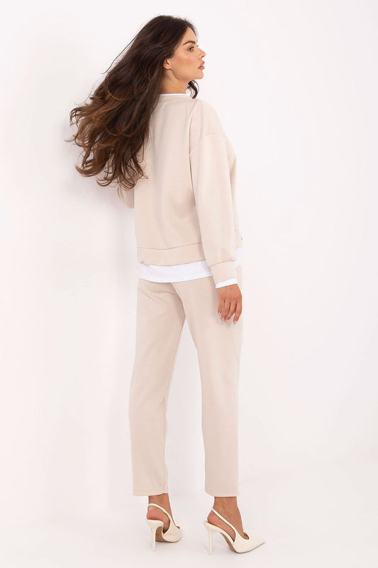 Stylish close-up of Rue Paris women's casual set, showcasing a comfortable round neck sweatshirt and tailored high-waisted trousers, perfect for chic everyday wear.